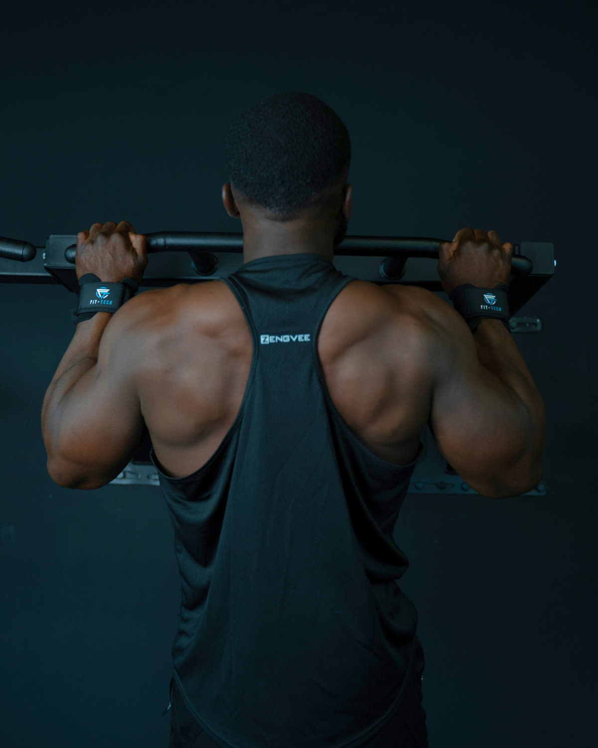 Lifter mid-row wearing lifting hooks, back working and hands relaxed